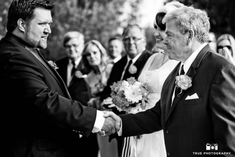 Bride's Dad shakes Grooms hand after walking daughter down wedding aisle