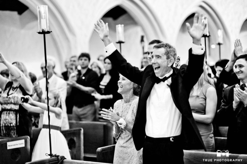 Excited Dad cheers and celebrates during wedding ceremony at church