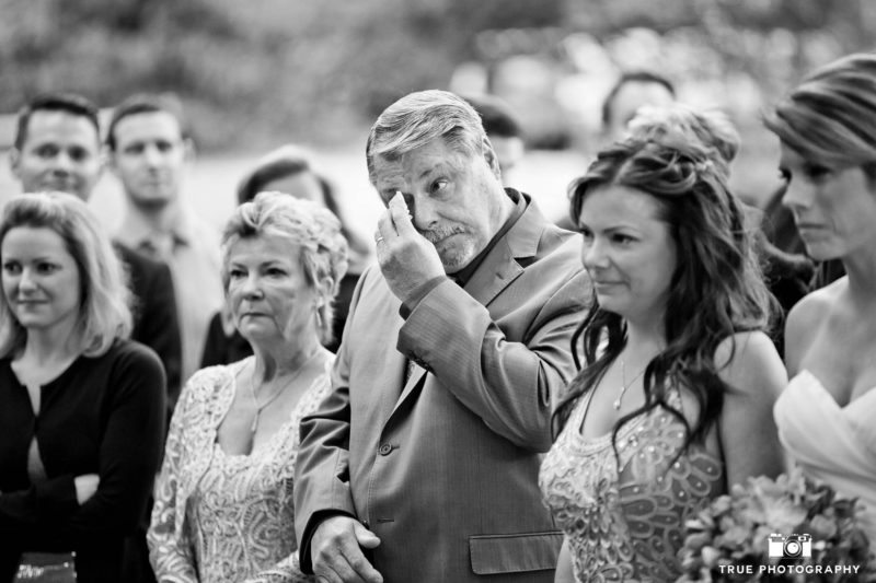 Bride's Dad uses handkerchief to wipe tears as he gets emotional watching wedding ceremony