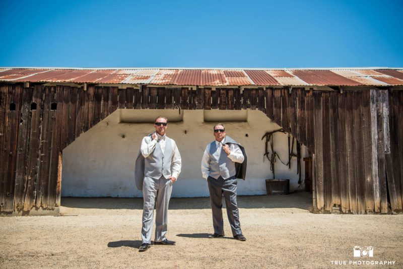 Groomsmen portraits with jackets off at rustic, spanish-style barn