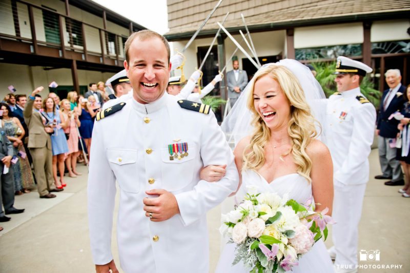 Bride and Navy military Groom exit ceremony laughing