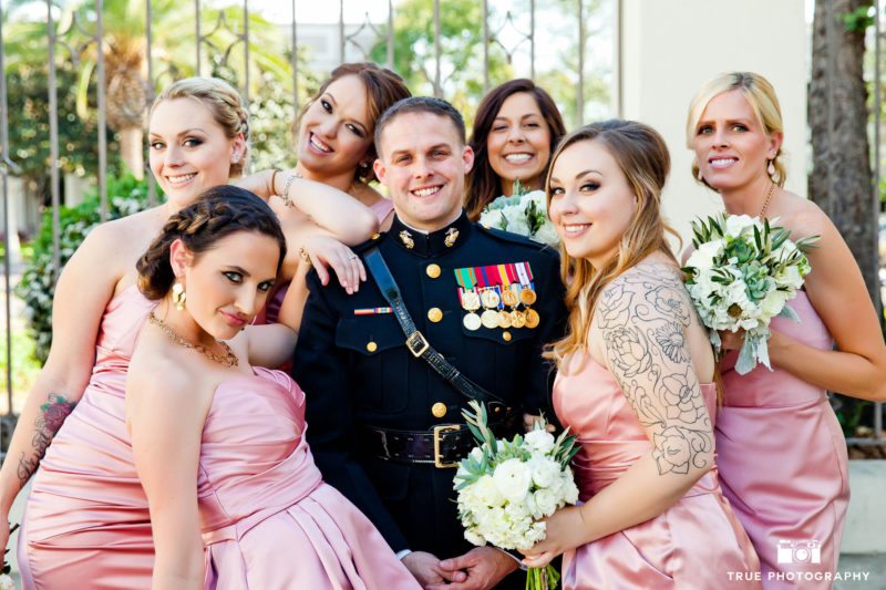 Military Groom poses with group of Bridesmaids before wedding ceremony