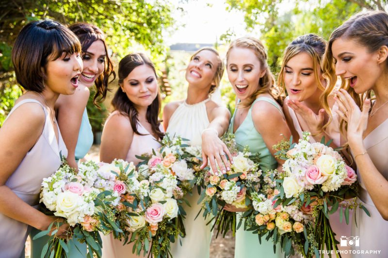 Bride shows off ring to bridesmaids for funny reaction