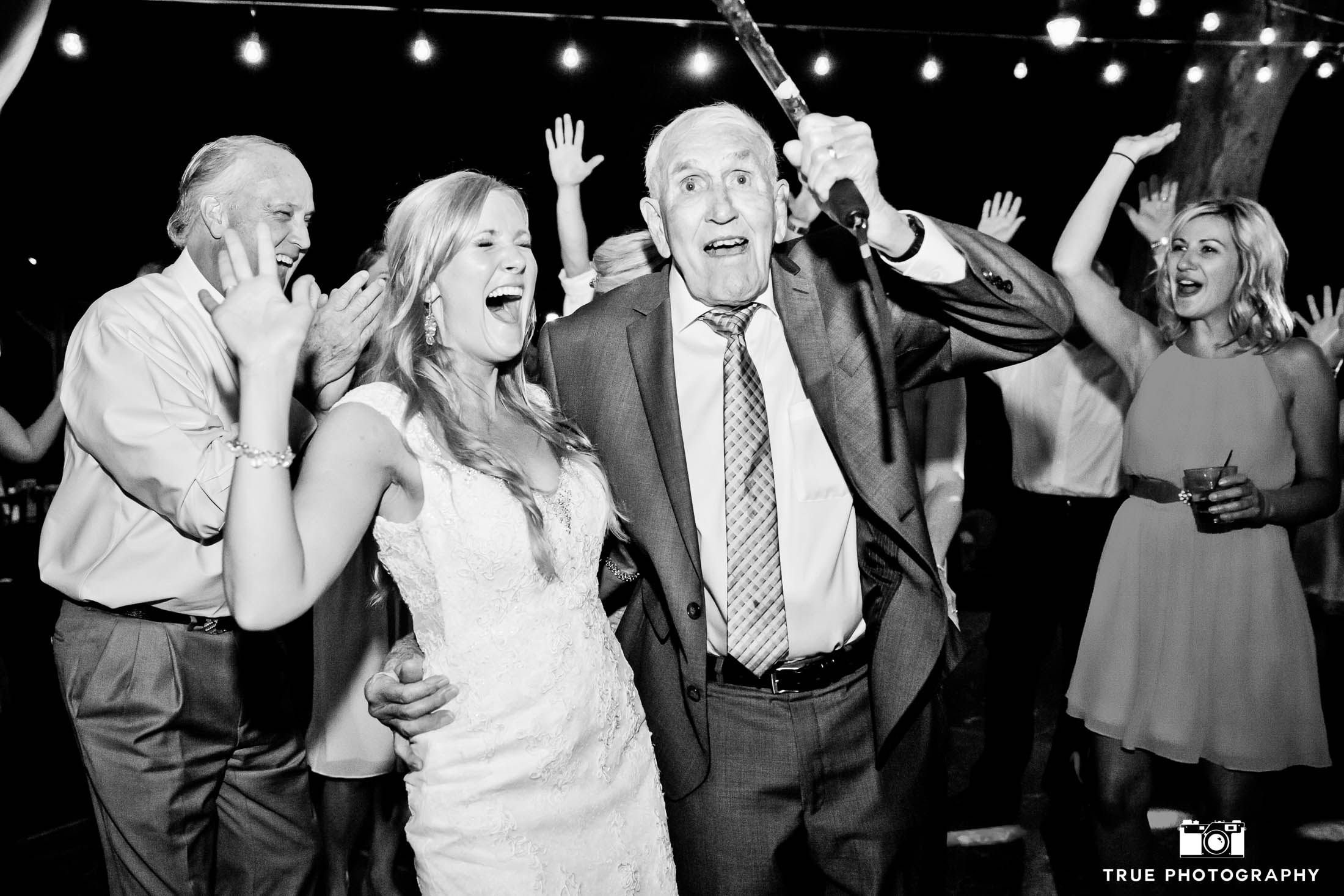 Bride makes funny face while dancing with dad during wedding reception