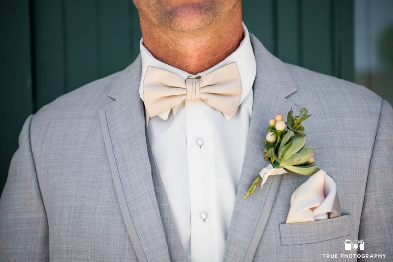 Close up of Groom's bow tie, boutonniere and pocket square