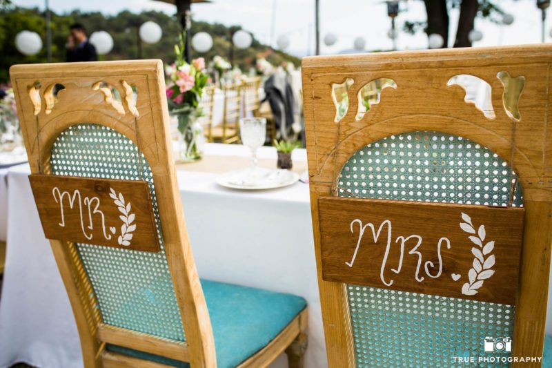 Custom rustic wicker chairs for bride and groom during outdoor reception