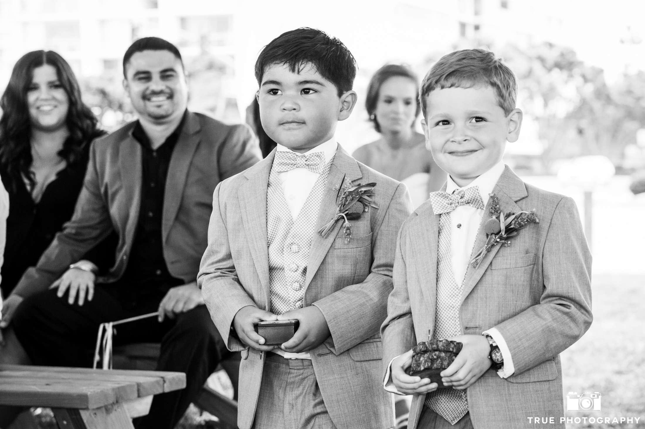 b&w photo of two ring bearers walking down the aisle