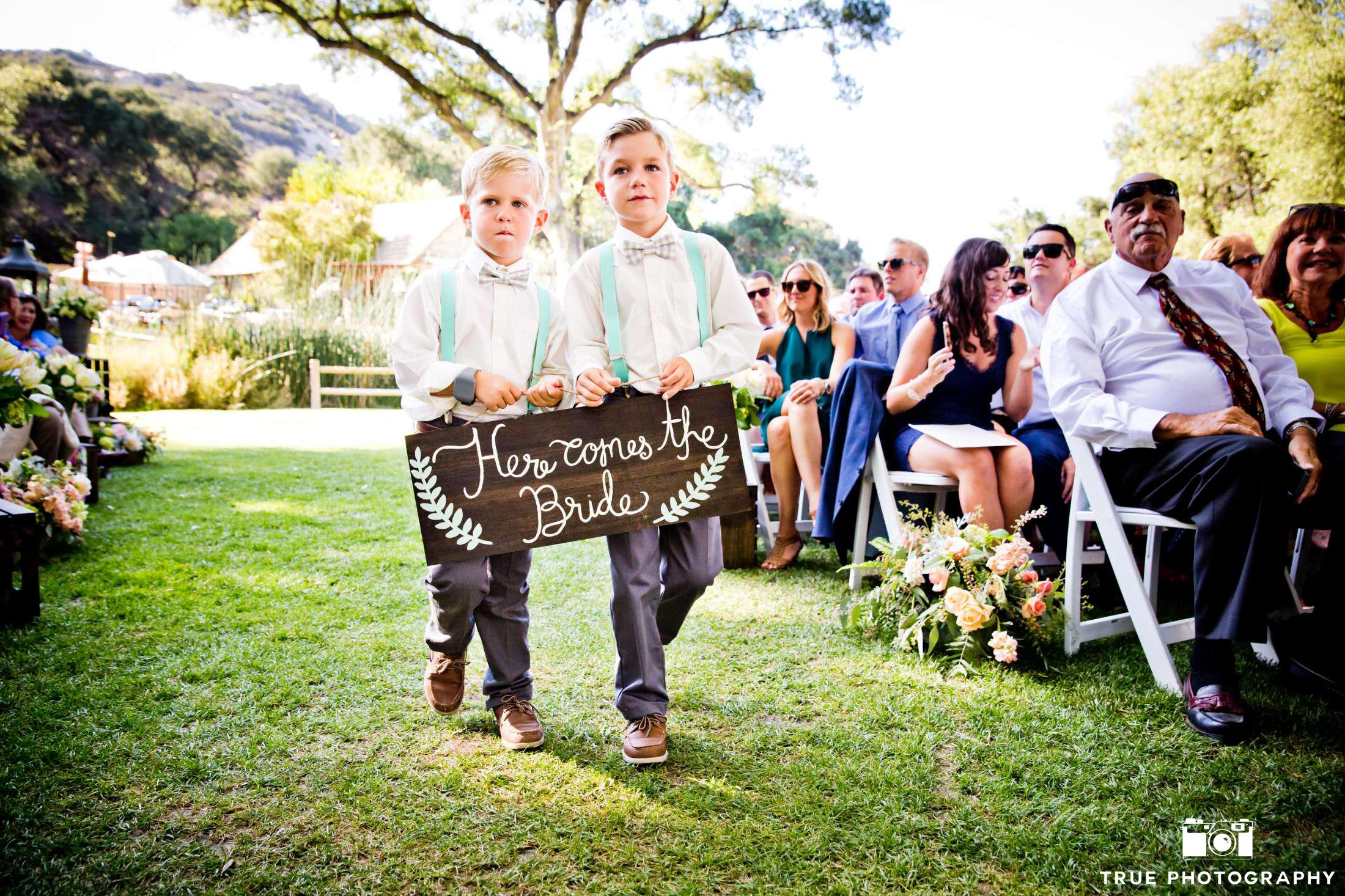 ring bearers holding sign