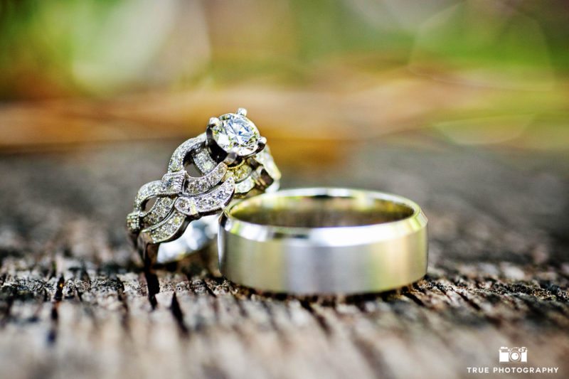 Bride's intricate sculptural wedding ring paired with Groom's white gold wedding band