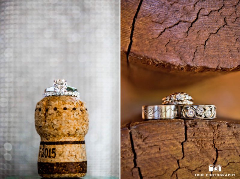 Intricately designed wedding rings placed on unique wood surface and wine cork