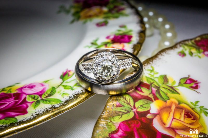 Bride's halo style interlocking wedding ring on porcelain plates