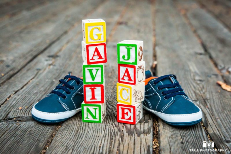 Baby shoes frame letter blocks during maternity session
