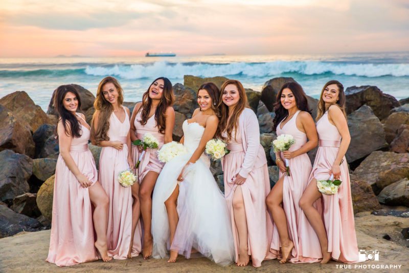 Bridesmaid have fun showing off legs in pink dresses by David's Bridal