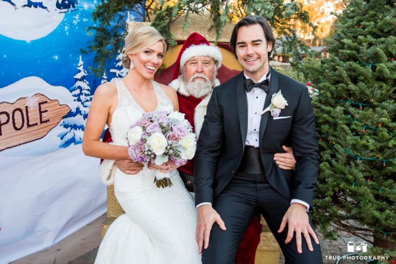 Bride and Groom sit on Santa's Lap for funny photo at Balboa Park