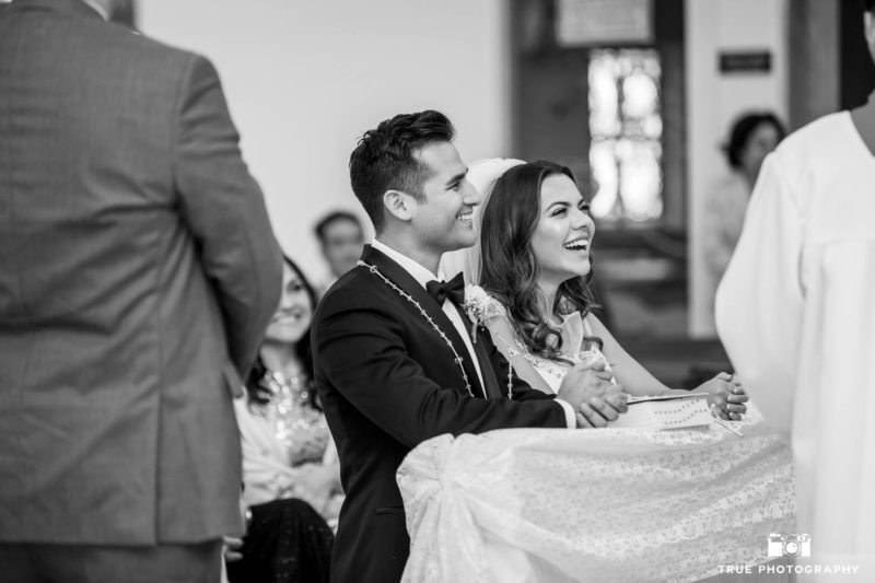 Bride and Groom laughing during church ceremony