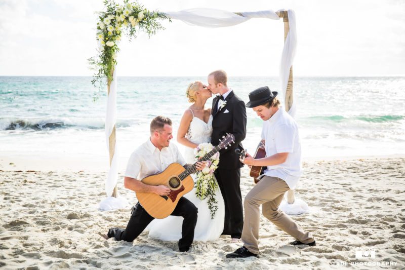 Wedding Couple kiss as musicians rock out