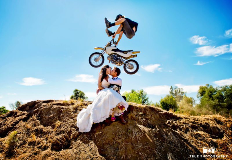 Wedding Couple Kiss as Dirtbiker performs trick