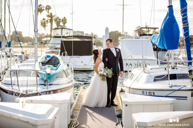 Bride and Groom look at one another in marina
