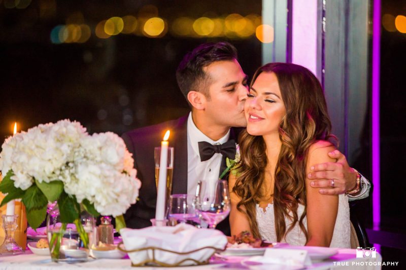 Groom kisses Bride at Sweetheart Table