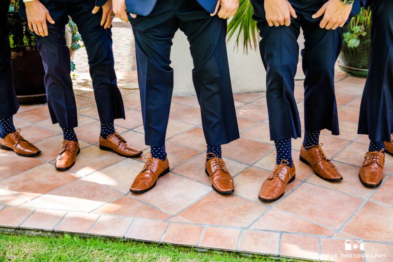 Groomsmen show off their matching sock and shoes