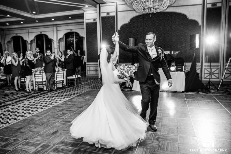 Groom twirls Bride during couple's first dance at reception