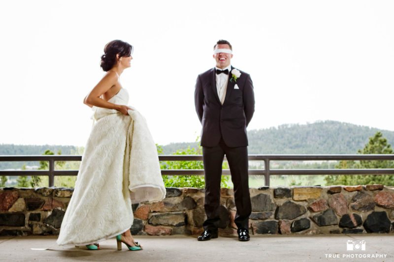 Bride tip toes around blindfolded groom