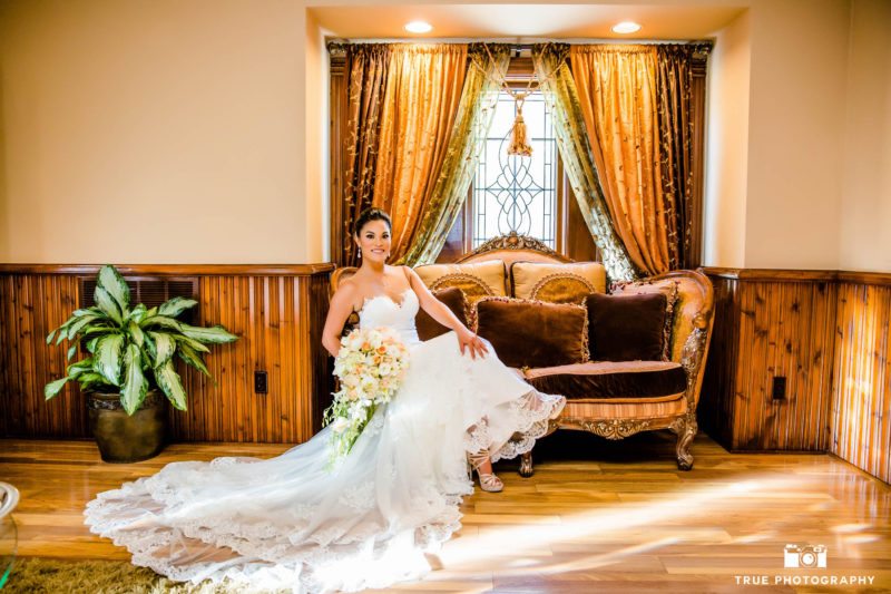Bride sits casually in her dress
