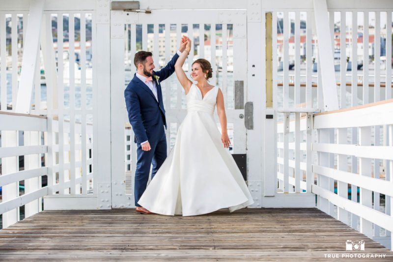 Bride and Groom dancing on a pier