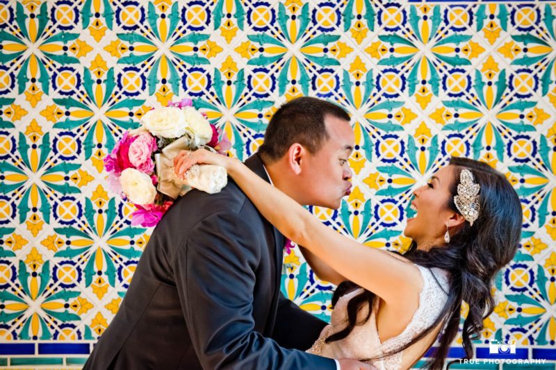Bride laughs as groom makes kissy face