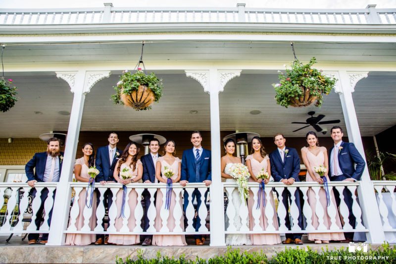 The mansion porch is a perfect place to take a bridal party photo.