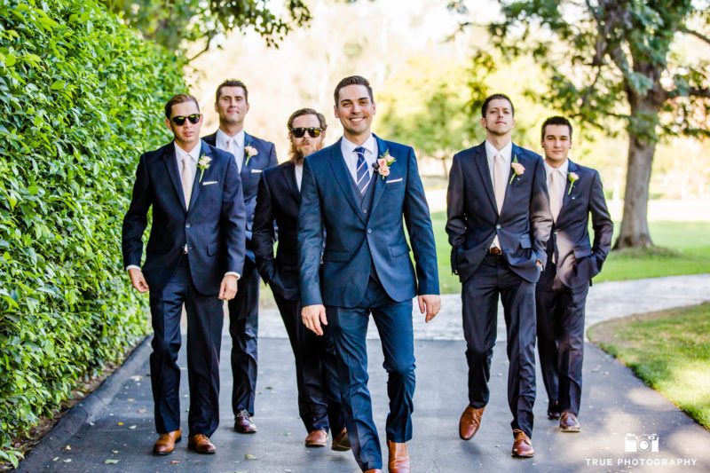 The groom and his groomsmen taking a walk