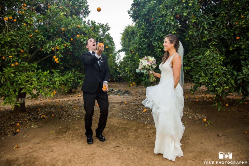groom juggles oranges for his bride on their wedding day