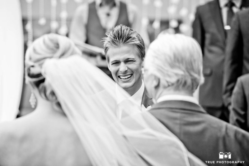 Groom smiles with glee when he sees his bride