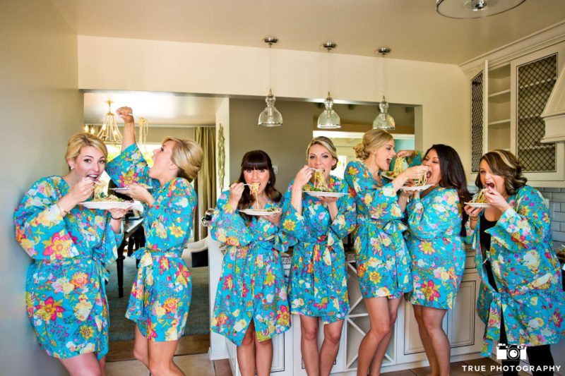 silly bridesmaids eating spaghetti before the wedding starts