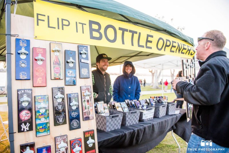 Eventgoer talks to Flip It Bottle Openers during Best Coast Beer Fest