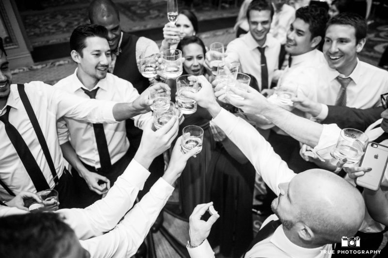 wedding guests toast the couple with shots during the reception