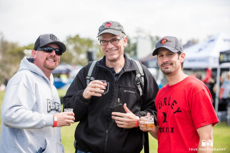 Three male friends drink local craft beer during Best Coast Beer Fest in Embarcadero Park
