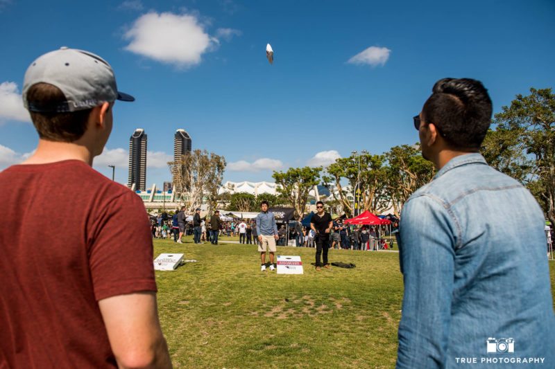 Friends play lawn games during cancer charity event, Best Coast Beer Fest