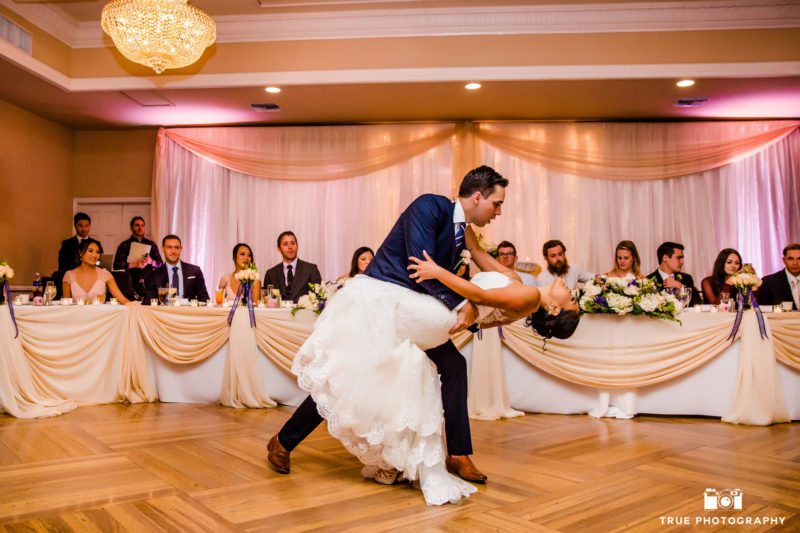 Groom dips his bride for their first dance