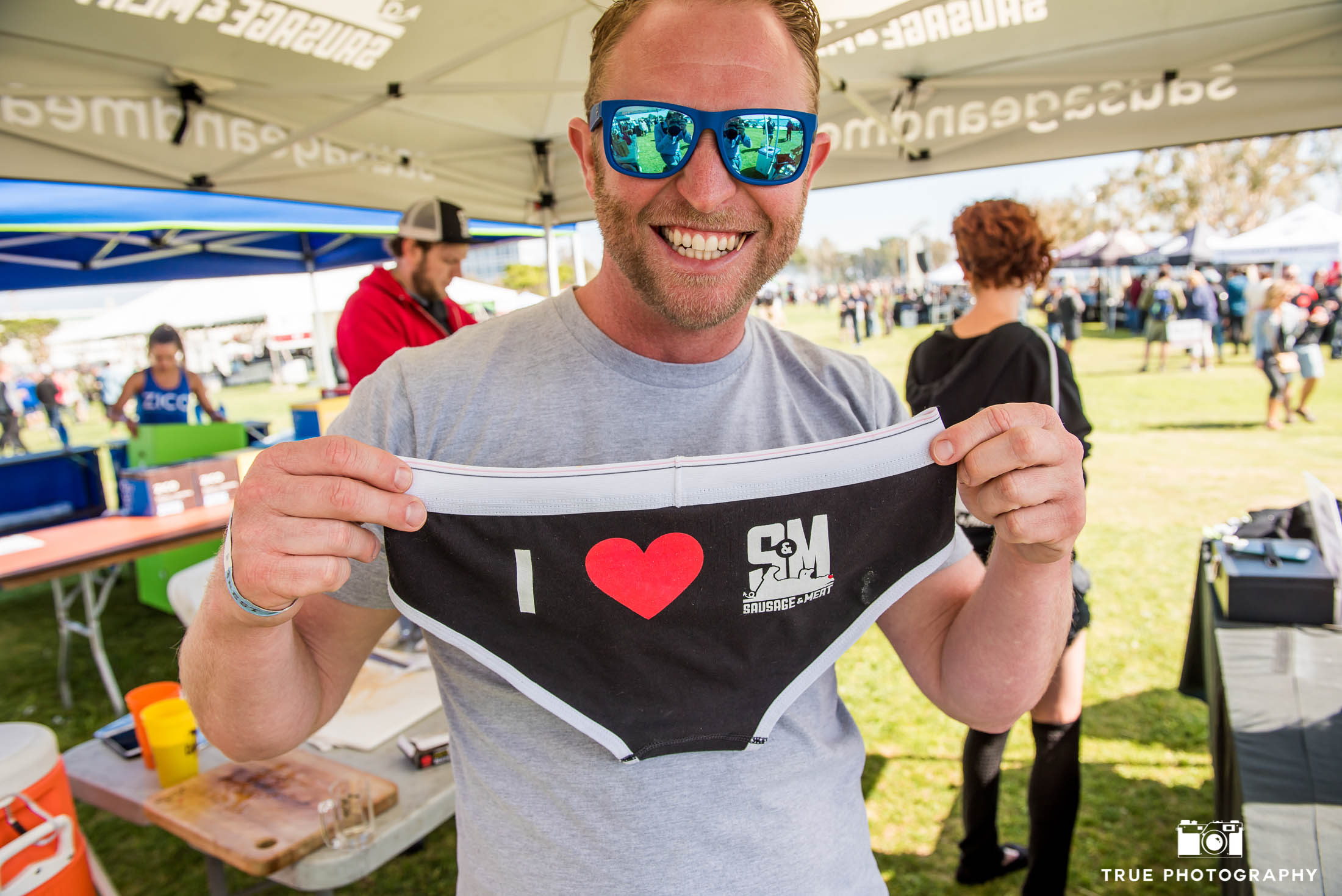 Event goer with Sausage and Meat underwear merchandise during Best Coast Beer Fest