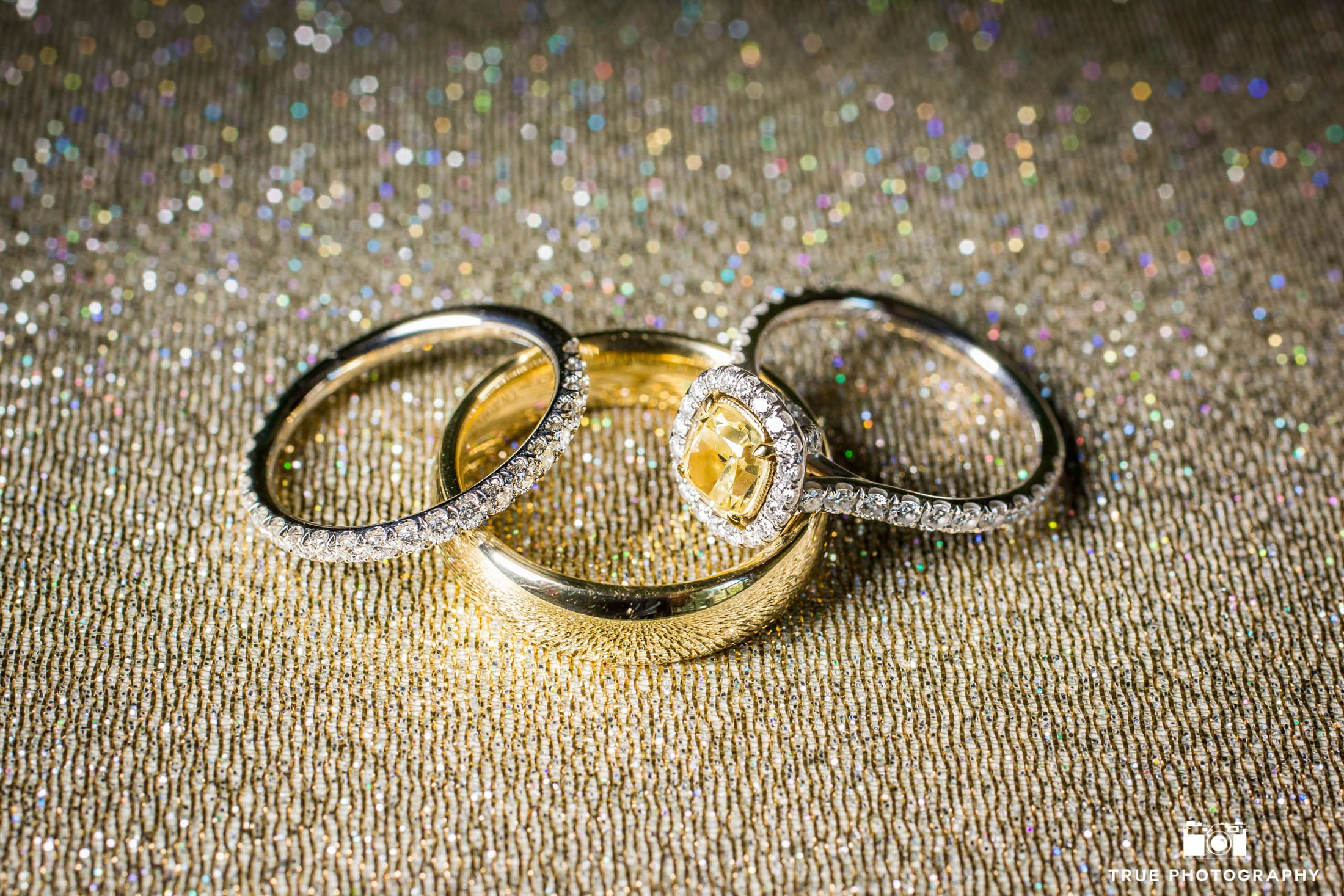Close up shot of diamond ring and wedding bands