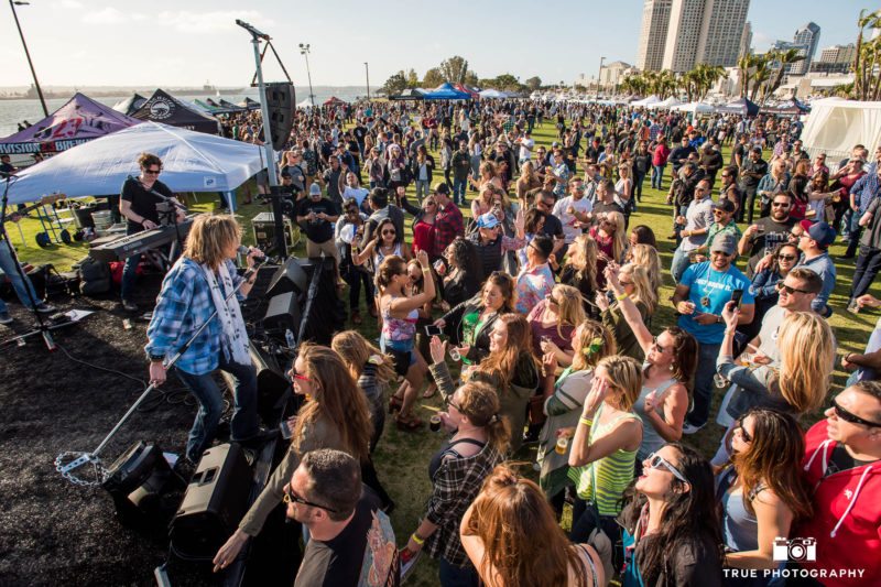 Live band performs for crowd on lawn of Embarcadero Park during beer festival
