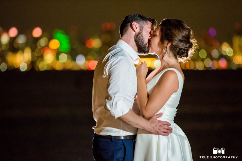 Night wedding photo in front of San Diego skyline