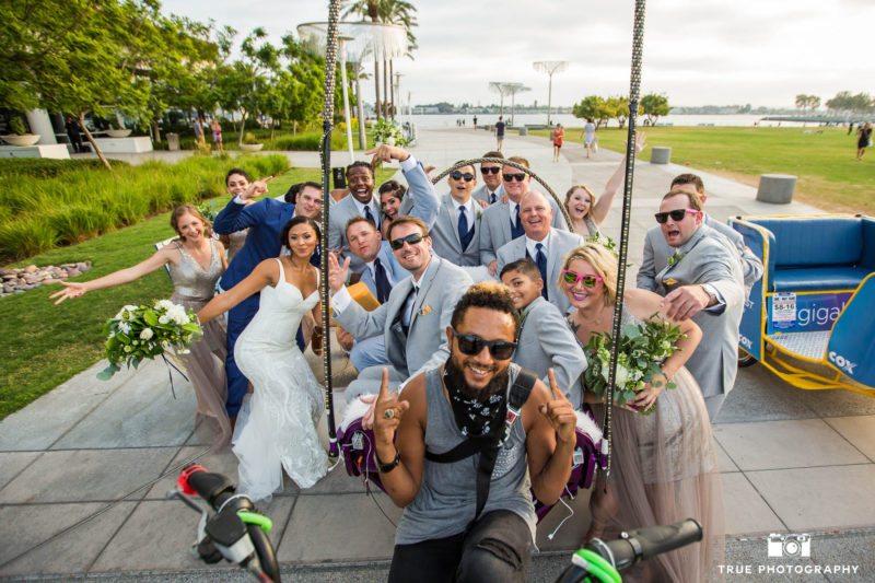 candid photo of funny bridal party with pedicart driver