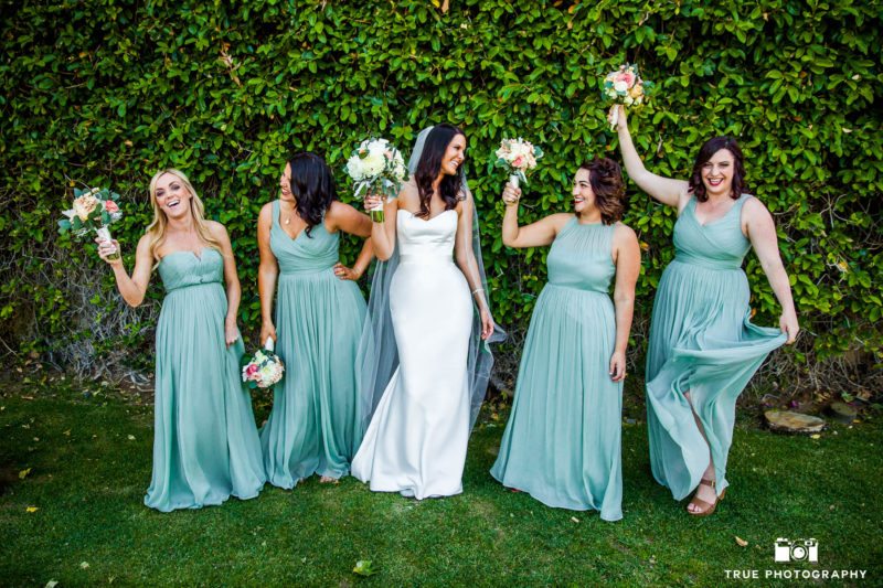 Funny Bridesmaids hold up bouquets