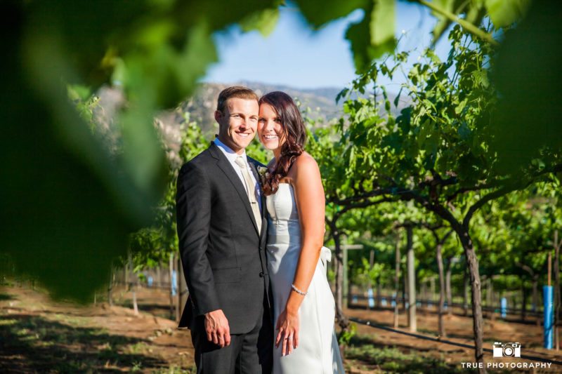Bride and Groom smiling in vineyard
