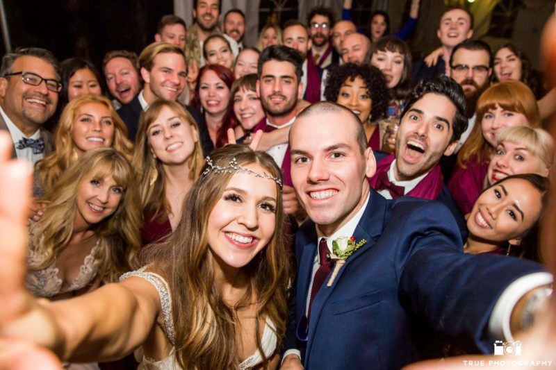A newly married couple captures the moment with a selfie.