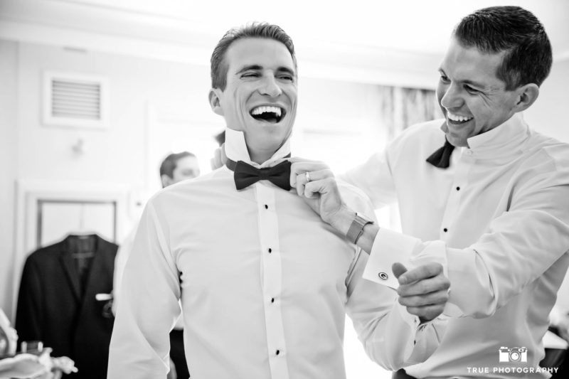 Groom laughing with groomsmen