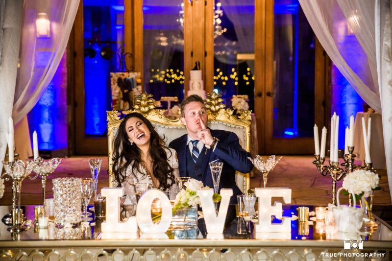 Bride and Groom react during toasts at sweetheart table