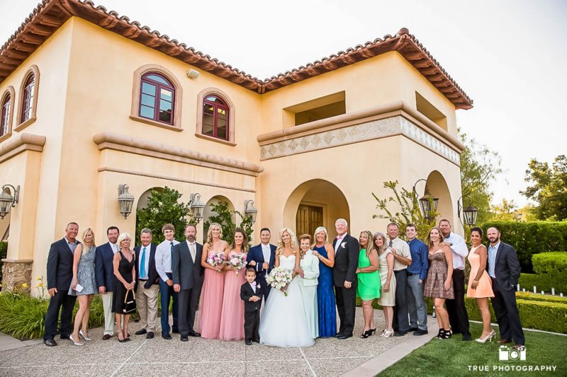 Both the groom and bride's side of the family come together for a full family photo